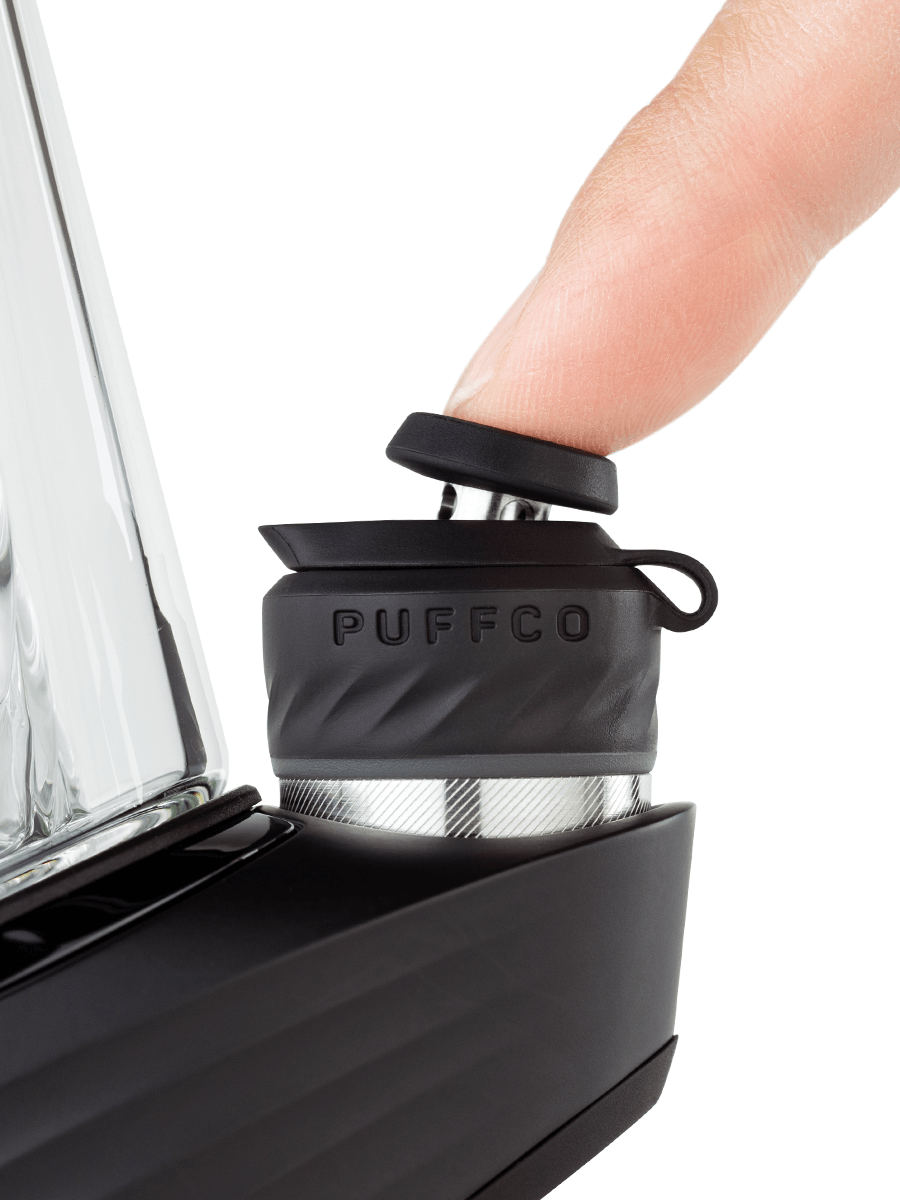  Close up shot of Puffco black chamber with finger on top 