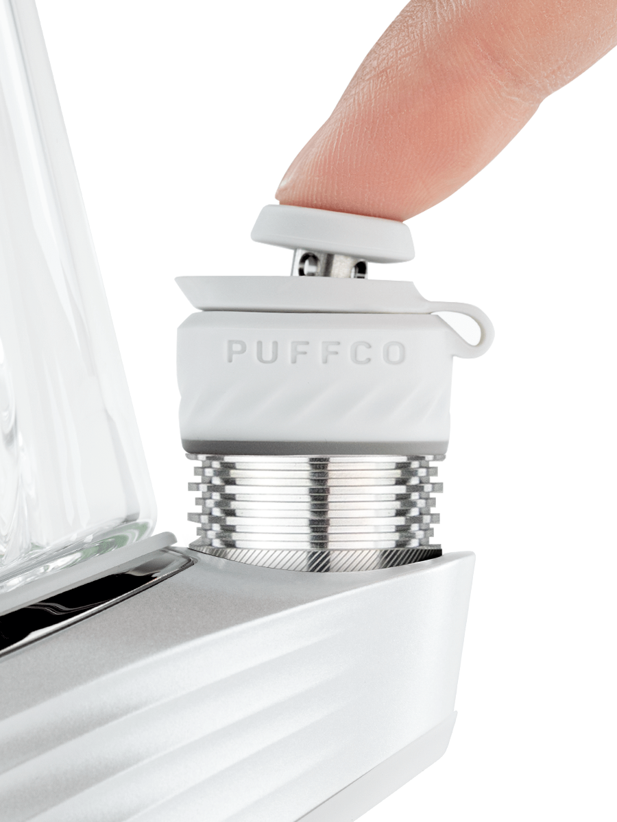 finger pressing white dab rig joystick
