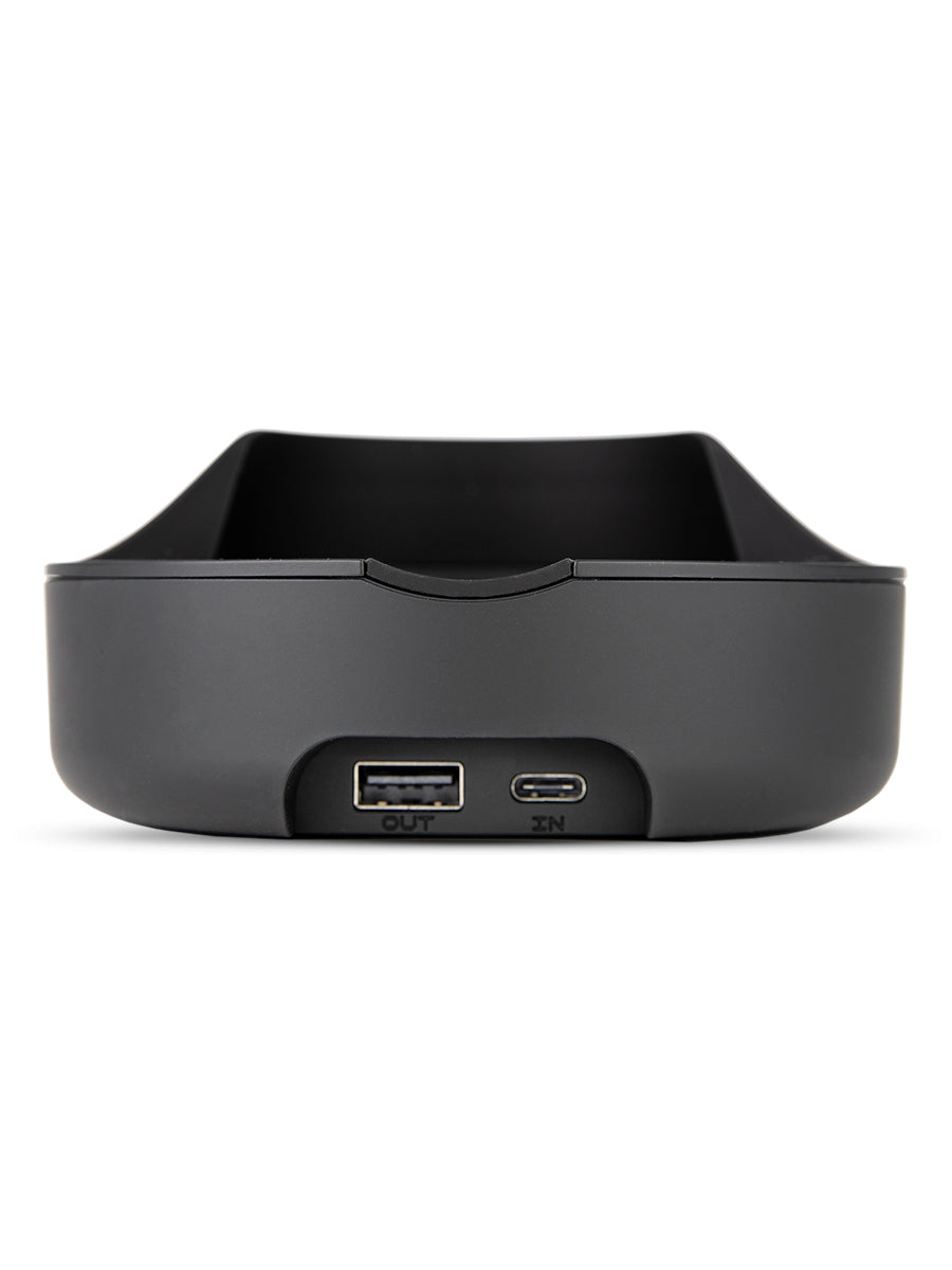 Shot of the back of black Puffco wireless charger including two ports against white backdrop