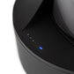 Close up shot of four small blue and white lights on black Puffco wireless charger