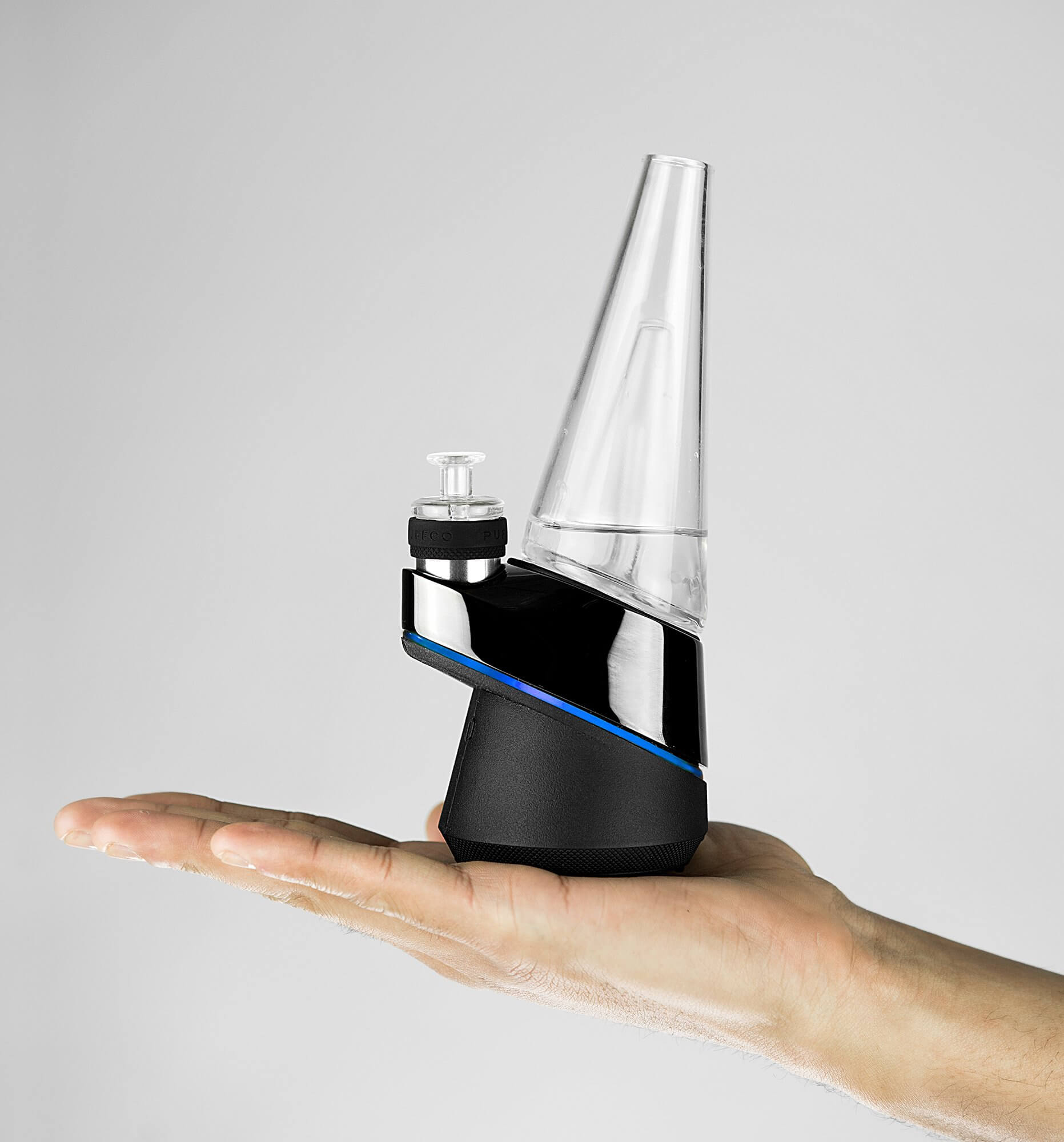  Side shot of hand holding Puffco black thc concentrate vaporizer
