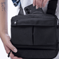 Close up of a person holding a Puffco black Proxy travel bag and placing a cellphone into the back compartment